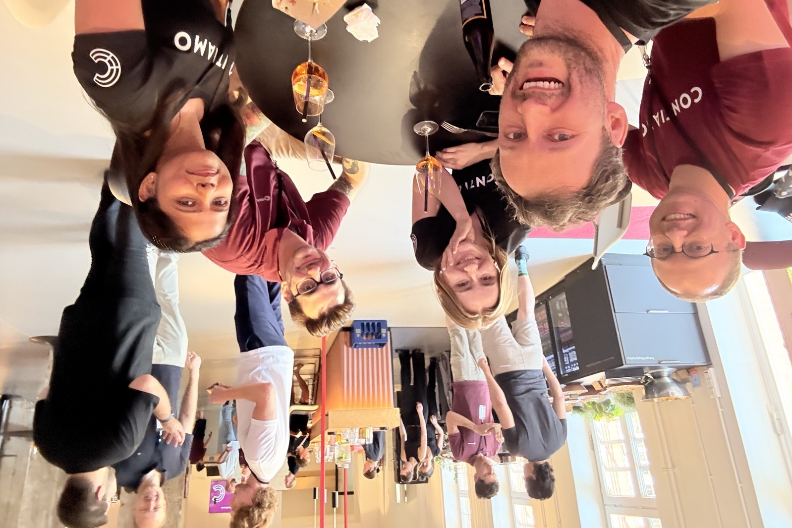 Contiamo colleagues around a table at a summer event